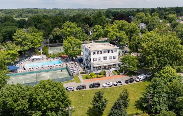 42-30 Douglaston Pkwy Unit 7H, Douglaston, NY 11363 - drone / aerial view of a pool area and a heavily wooded area