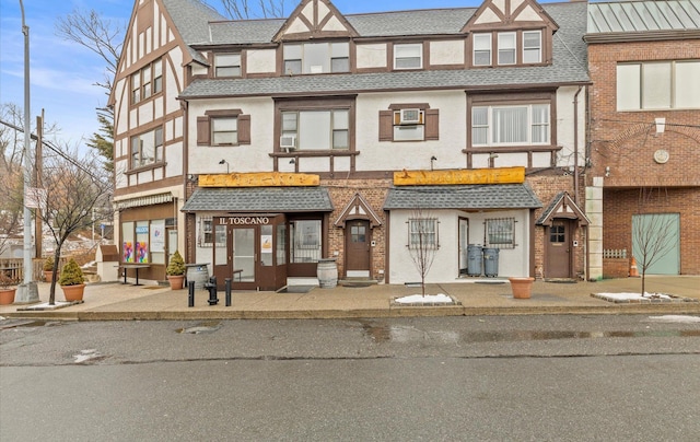 42-30 Douglaston Pkwy Unit 7H, Douglaston, NY 11363 - townhome / multi-family property with stucco siding, a shingled roof, and brick siding