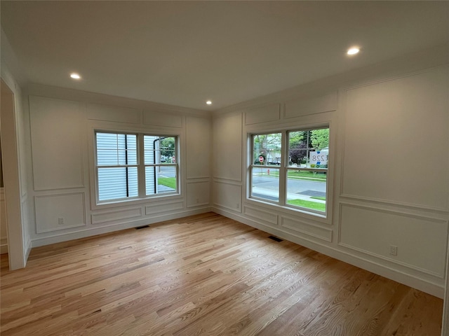 228 Latham Rd, Mineola, NY 11501 - unfurnished room featuring a decorative wall, healthy amount of natural light, light wood finished floors, and recessed lighting
