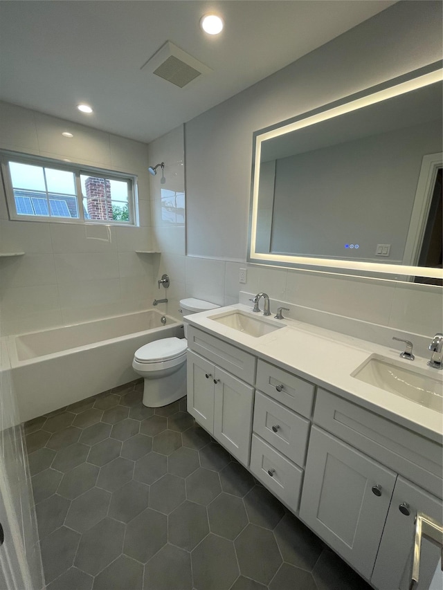228 Latham Rd, Mineola, NY 11501 - full bath featuring double vanity, toilet,  shower combination, recessed lighting, and tile patterned flooring