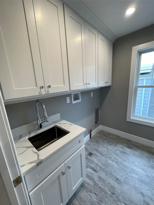 228 Latham Rd, Mineola, NY 11501 - laundry room featuring washer hookup, cabinet space, baseboards, light wood-style flooring, and recessed lighting