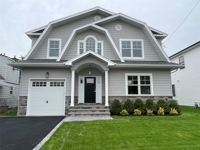 228 Latham Rd, Mineola, NY 11501 - dutch colonial with a gambrel roof, stone siding, and a front yard