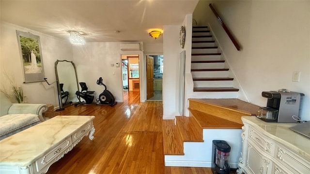 154-6 64th Ave, Flushing, NY 11367 - living area featuring stairway, wood finished floors, and a wall mounted air conditioner