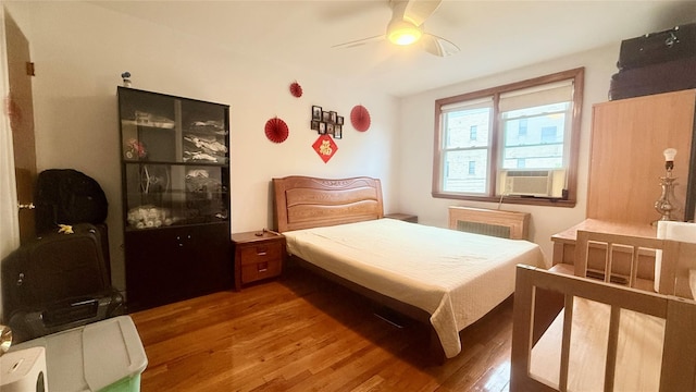 154-6 64th Ave, Flushing, NY 11367 - bedroom featuring cooling unit, wood finished floors, ceiling fan, and radiator