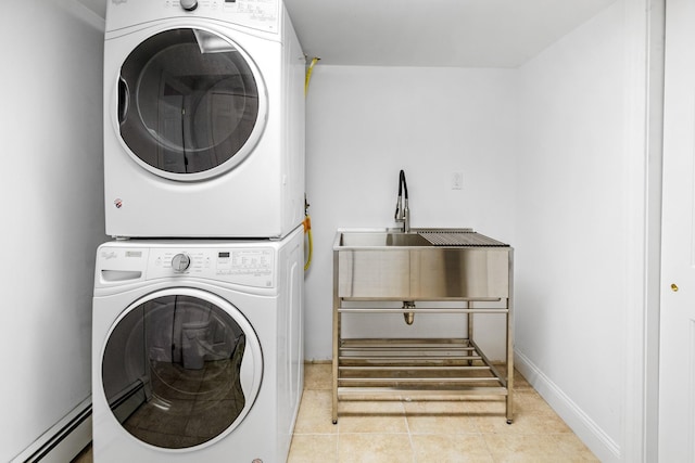 5 Ponds Rd, Water Mill, NY 11976 - laundry room featuring baseboard heating, stacked washer / dryer, and tile patterned flooring