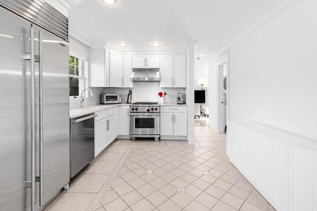 5 Ponds Rd, Water Mill, NY 11976 - kitchen featuring premium appliances, under cabinet range hood, ornamental molding, light countertops, and backsplash