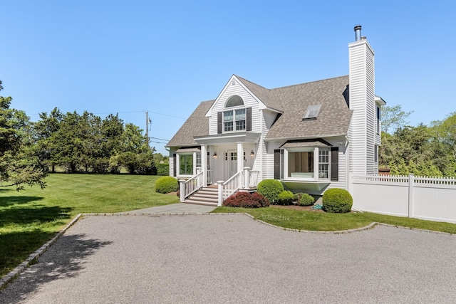 5 Ponds Rd, Water Mill, NY 11976 - view of front facade with roof with shingles and a chimney
