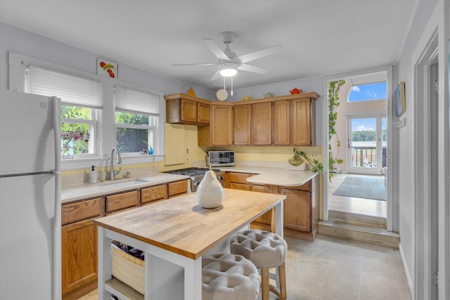 3 Makamah Beach Rd, Northport, NY 11768 - kitchen with freestanding refrigerator, a sink, a ceiling fan, butcher block countertops, and a water view