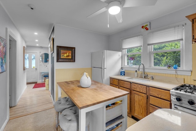 3 Makamah Beach Rd, Northport, NY 11768 - kitchen featuring freestanding refrigerator, a sink, wooden counters, gas range oven, and healthy amount of natural light