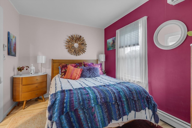 3 Makamah Beach Rd, Northport, NY 11768 - bedroom featuring baseboard heating, wood finished floors, and crown molding