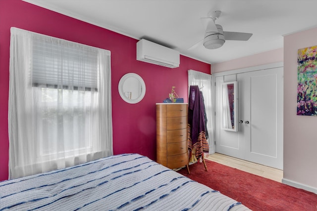 3 Makamah Beach Rd, Northport, NY 11768 - bedroom with an AC wall unit, ceiling fan, and wood finished floors