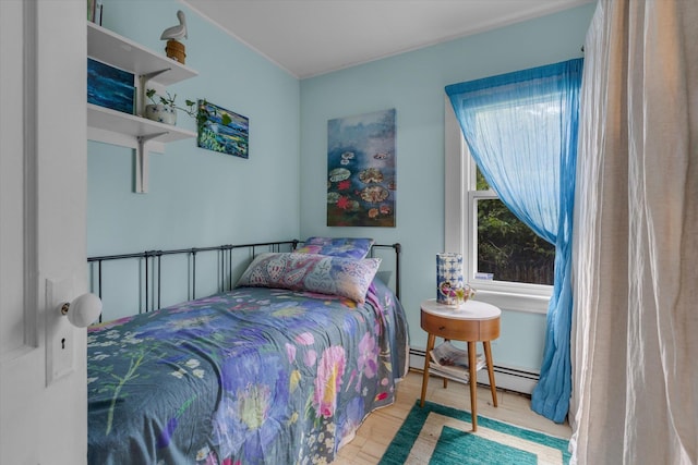 3 Makamah Beach Rd, Northport, NY 11768 - bedroom with a baseboard radiator and wood finished floors