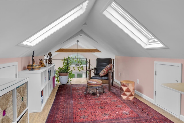 3 Makamah Beach Rd, Northport, NY 11768 - sitting room with a skylight, vaulted ceiling, light wood-style flooring, and baseboards