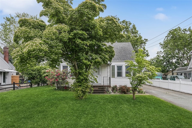 142 Woodhull Ave, Riverhead, NY 11901 - view of front of house featuring a shingled roof and asphalt driveway