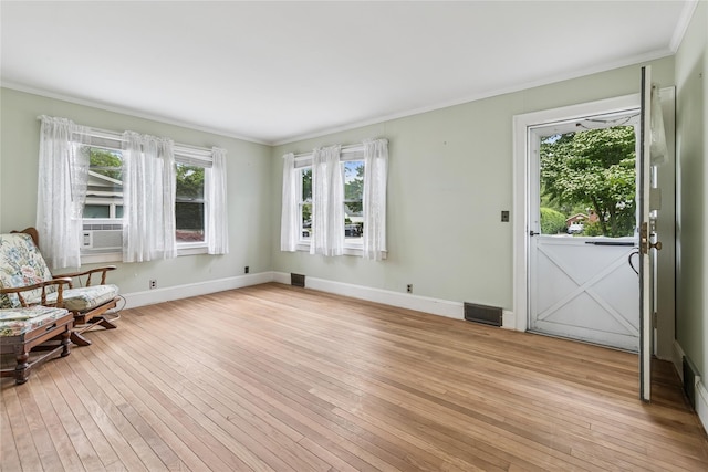 142 Woodhull Ave, Riverhead, NY 11901 - unfurnished room featuring light wood finished floors, crown molding, baseboards, and cooling unit