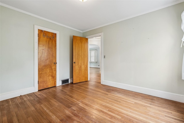 142 Woodhull Ave, Riverhead, NY 11901 - unfurnished bedroom with wood-type flooring, baseboards, and crown molding