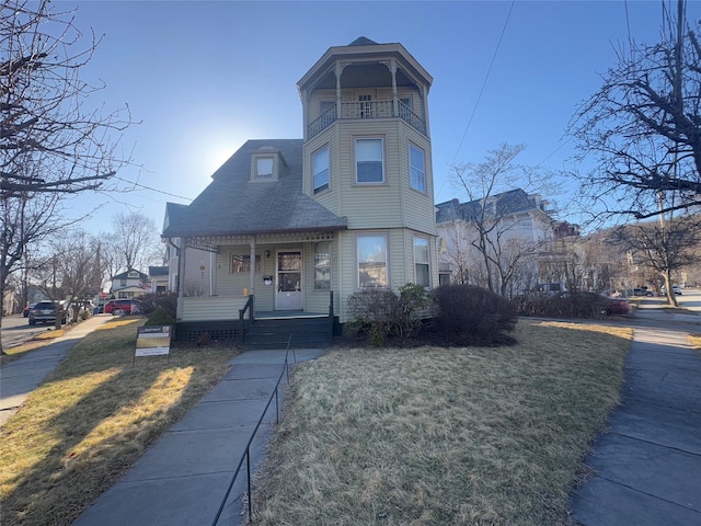 25 E Broome St, Port Jervis, NY 12771 - victorian home with a porch, a balcony, roof with shingles, and a front yard