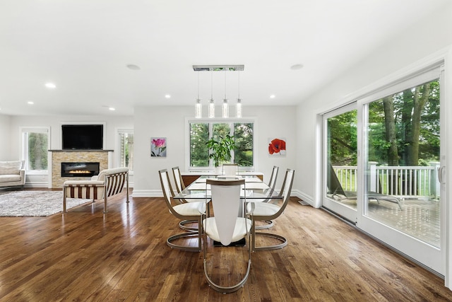 1 Berkley Ct, Briarcliff Manor, NY 10510 - dining room with healthy amount of natural light, a glass covered fireplace, dark wood-type flooring, recessed lighting, and baseboards