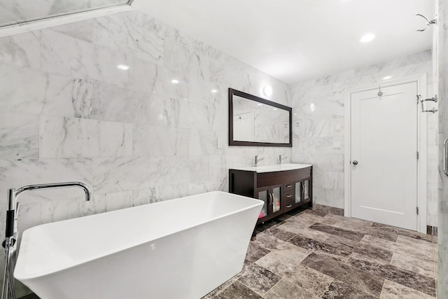 1 Berkley Ct, Briarcliff Manor, NY 10510 - bathroom featuring double vanity, tile walls, and a soaking tub