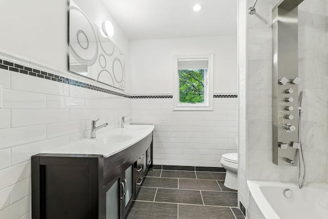 1 Berkley Ct, Briarcliff Manor, NY 10510 - full bathroom with tile walls, toilet, double vanity, a wainscoted wall, and  shower combination
