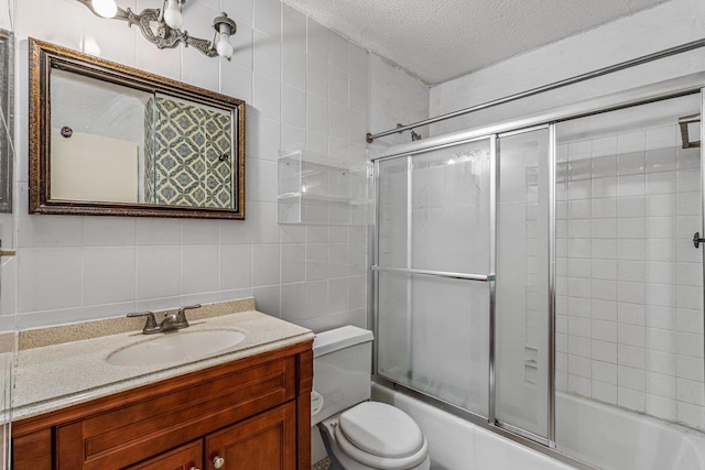 152-18 Union Tpke Unit 4G, Flushing, NY 11367 - full bathroom featuring tile walls, a textured ceiling, vanity, enclosed tub / shower combo, and toilet