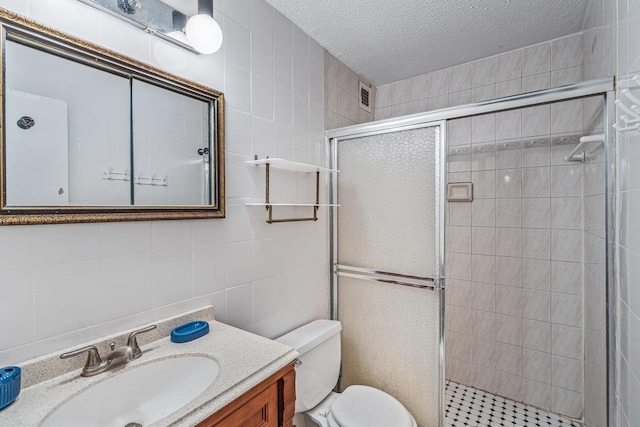 152-18 Union Tpke Unit 4G, Flushing, NY 11367 - bathroom with tile walls, a shower stall, toilet, a textured ceiling, and vanity