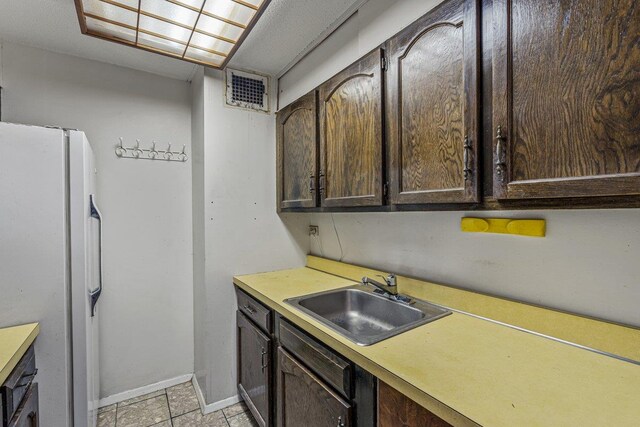 152-18 Union Tpke Unit 4G, Flushing, NY 11367 - kitchen with a sink, freestanding refrigerator, dark brown cabinets, baseboards, and light countertops