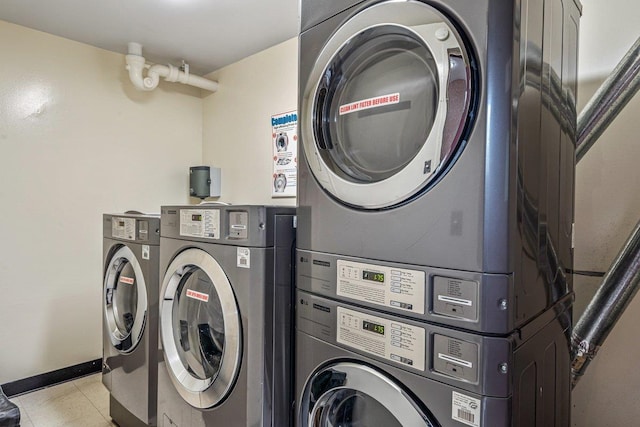 152-18 Union Tpke Unit 4G, Flushing, NY 11367 - laundry room with estacked washer and dryer, light tile patterned floors, and baseboards