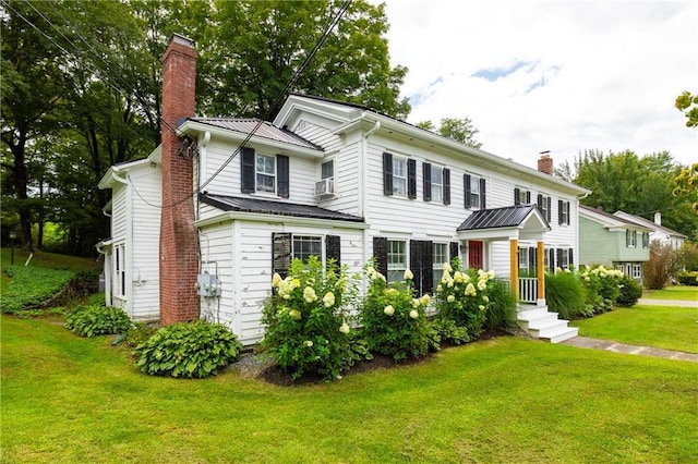 2-4 Hunns Lake Rd, Stanfordville, NY 12581 - view of front of house featuring a chimney, a front yard, metal roof, and cooling unit