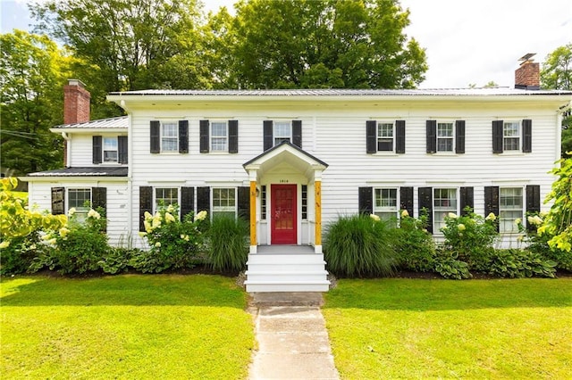 2-4 Hunns Lake Rd, Stanfordville, NY 12581 - colonial house featuring a chimney, a front yard, and metal roof