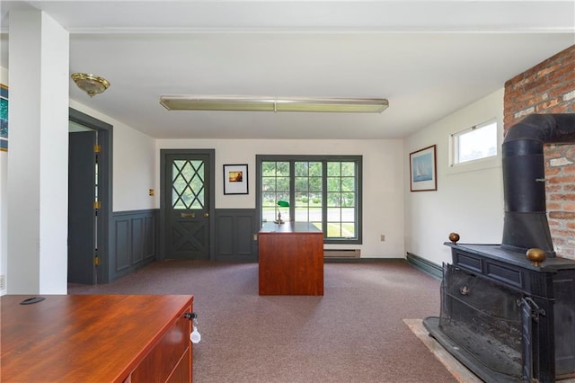 2-4 Hunns Lake Rd, Stanfordville, NY 12581 - carpeted living area with a wood stove, a wainscoted wall, and healthy amount of natural light