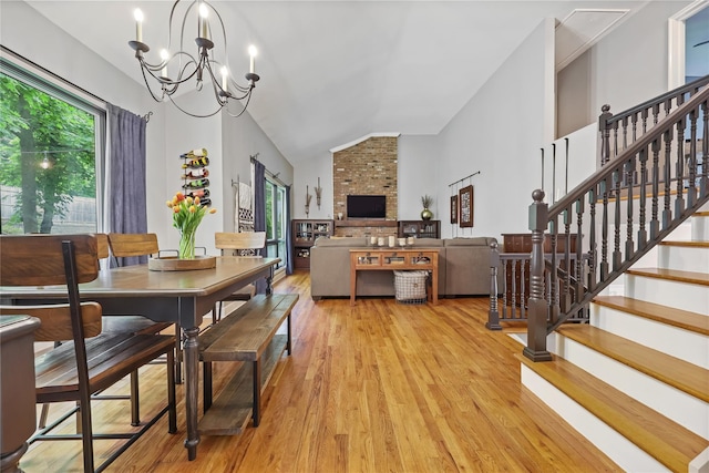 243 Albemarle Rd, White Plains, NY 10605 - dining room with lofted ceiling, light wood-style floors, a chandelier, and stairs