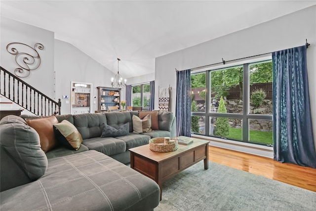 243 Albemarle Rd, White Plains, NY 10605 - living area featuring a chandelier, vaulted ceiling, wood finished floors, and stairway