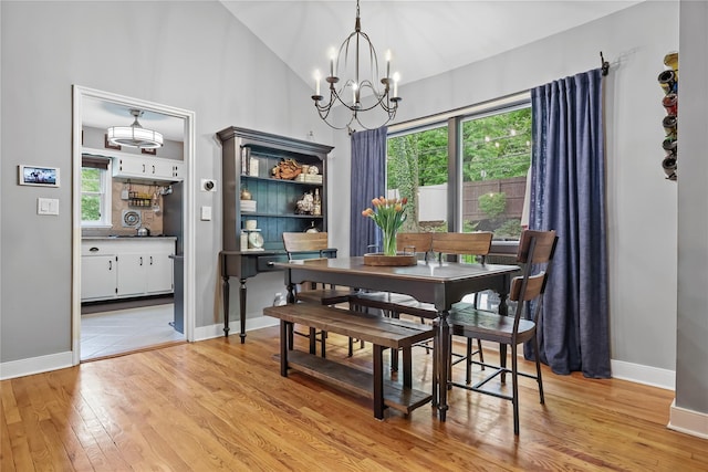243 Albemarle Rd, White Plains, NY 10605 - dining room with a chandelier, light wood-type flooring, high vaulted ceiling, and baseboards