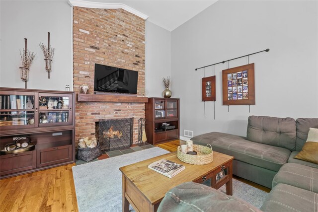 243 Albemarle Rd, White Plains, NY 10605 - living room featuring a brick fireplace, wood finished floors, and high vaulted ceiling