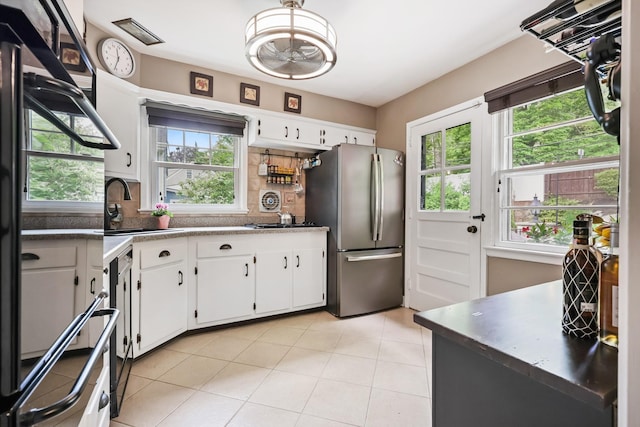 243 Albemarle Rd, White Plains, NY 10605 - kitchen with freestanding refrigerator, refrigerator, a sink, white cabinets, and decorative backsplash