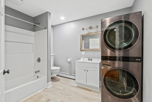 100 Schnackenberg Rd, Call Listing Agent, NY 12075 - full bath featuring stacked washer and clothes dryer, a baseboard radiator, toilet, vanity, and wood finished floors