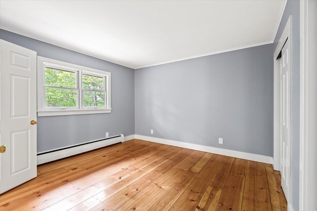 100 Schnackenberg Rd, Call Listing Agent, NY 12075 - empty room featuring a baseboard heating unit, hardwood / wood-style floors, ornamental molding, and baseboards