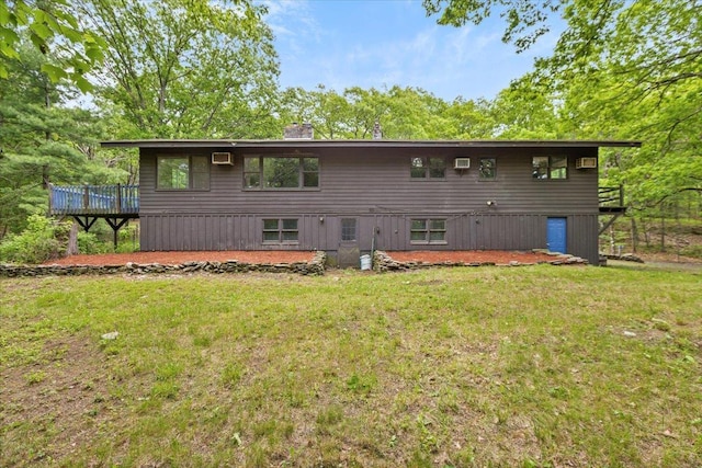 100 Schnackenberg Rd, Call Listing Agent, NY 12075 - back of property featuring a wooden deck, a lawn, a chimney, and a wall mounted air conditioner