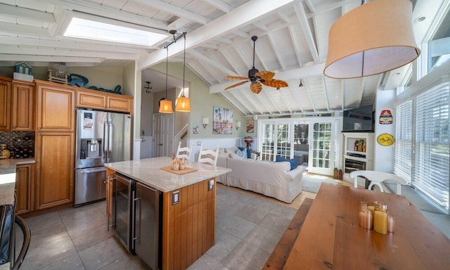 31 Gull Walk, Dunewood, NY 11706 - kitchen featuring stainless steel fridge, open floor plan, beverage cooler, a ceiling fan, and a center island