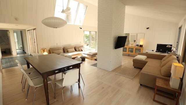 40 Elm Walk, Fair Harbor, NY 11706 - dining area featuring high vaulted ceiling, a fireplace, and light wood finished floors