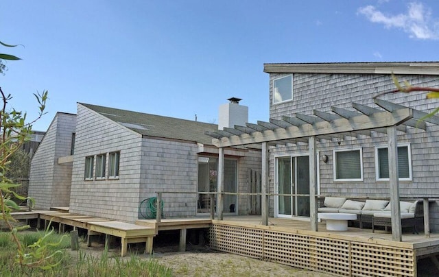 40 Elm Walk, Fair Harbor, NY 11706 - back of house featuring a wooden deck, a pergola, outdoor lounge area, and a chimney