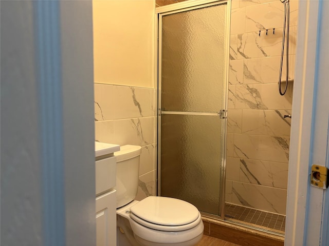 262 Grant Ave, Brooklyn, NY 11208 - bathroom with toilet, a stall shower, tile walls, vanity, and wainscoting