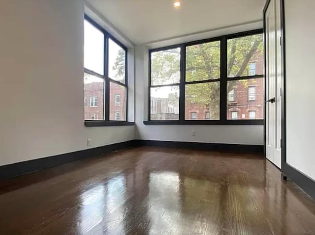 421 E 94th St, Brooklyn, NY 11212 - spare room featuring wood finished floors and baseboards