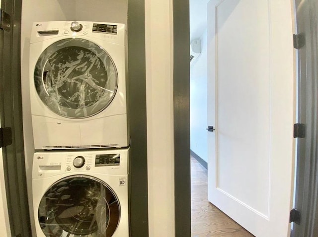 421 E 94th St, Brooklyn, NY 11212 - washroom featuring stacked washer / dryer and wood finished floors