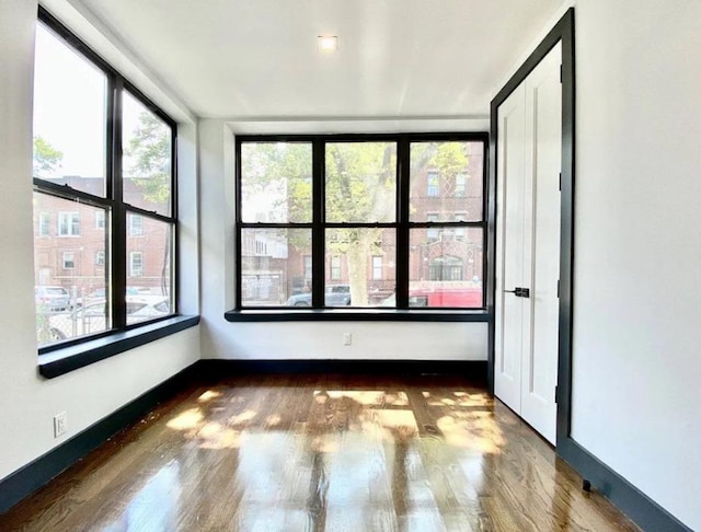 421 E 94th St, Brooklyn, NY 11212 - empty room featuring wood finished floors and baseboards