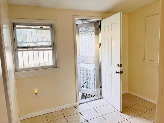 154-02 119th Ave, Jamaica, NY 11434 - doorway to outside with healthy amount of natural light, light tile patterned floors, and baseboards