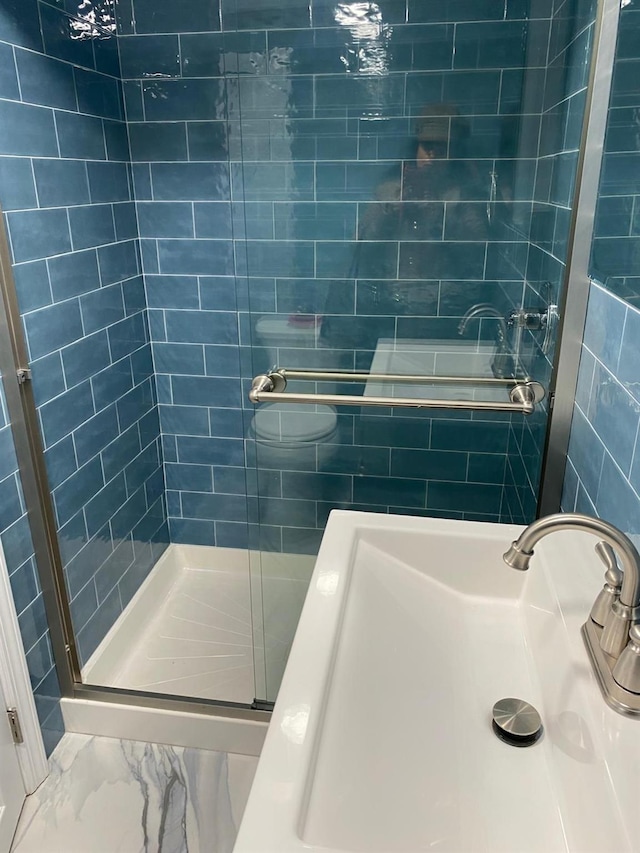 154-02 119th Ave, Jamaica, NY 11434 - full bath with a sink, marble look tiles, and tiled shower / bath