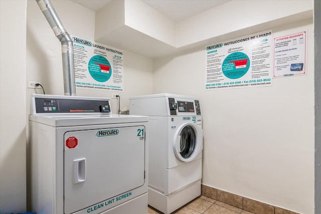 84-40 153rd Ave Unit 4F, Howard Beach, NY 11414 - communal laundry room with washer and clothes dryer, light tile patterned flooring, and baseboards