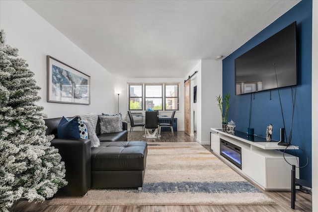 84-40 153rd Ave Unit 4F, Howard Beach, NY 11414 - living area featuring wood finished floors, a barn door, and baseboards